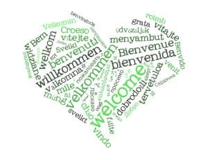 Het woord 'welkom' in verschillende talen in een hartvorm.